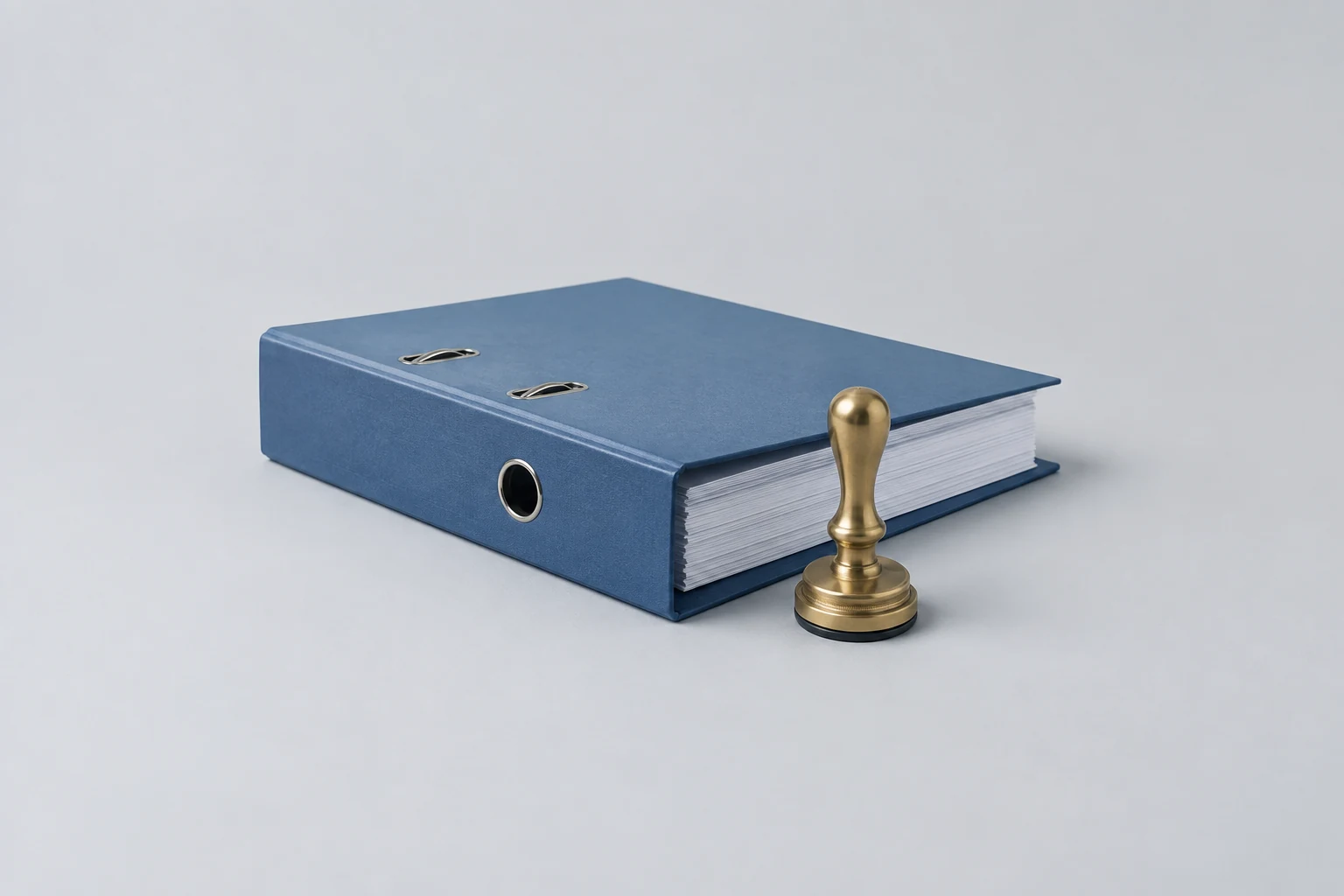 Ring binder of company records with a company seal embosser